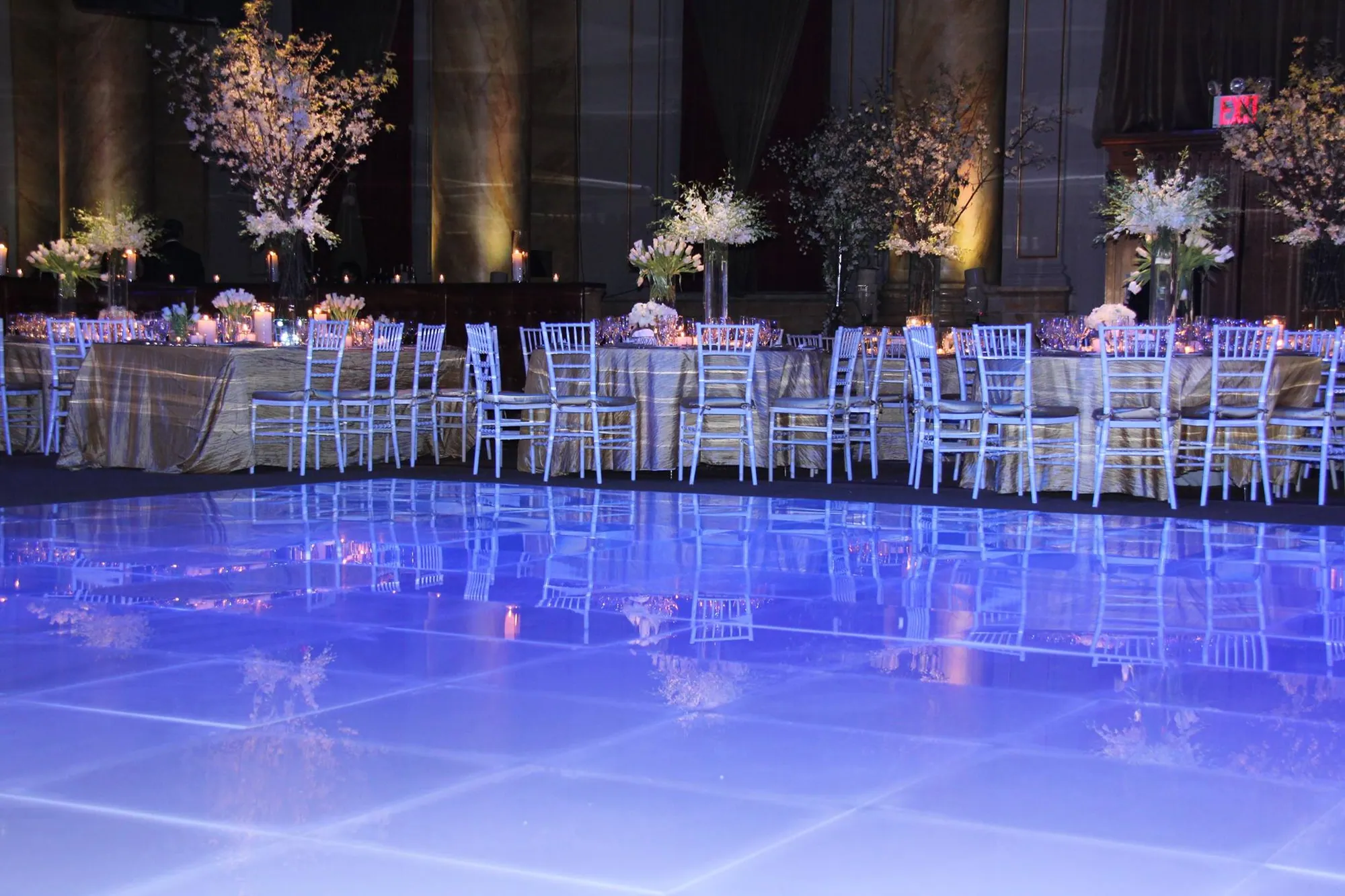 Gloss white T3 dance floor in a banquet hall set for dinner