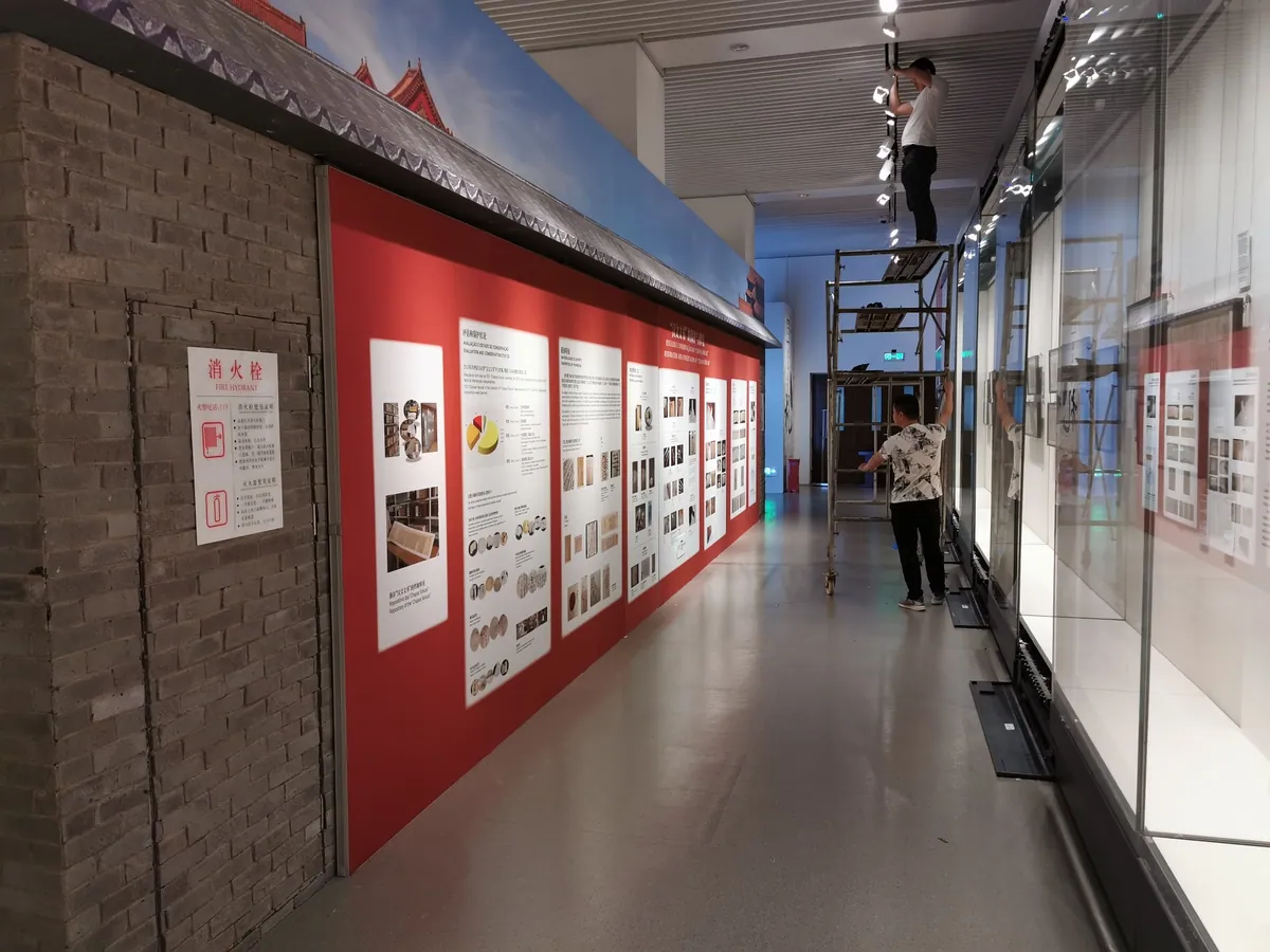 Museum gallery corridor lined with T3 graphic panels during installation
