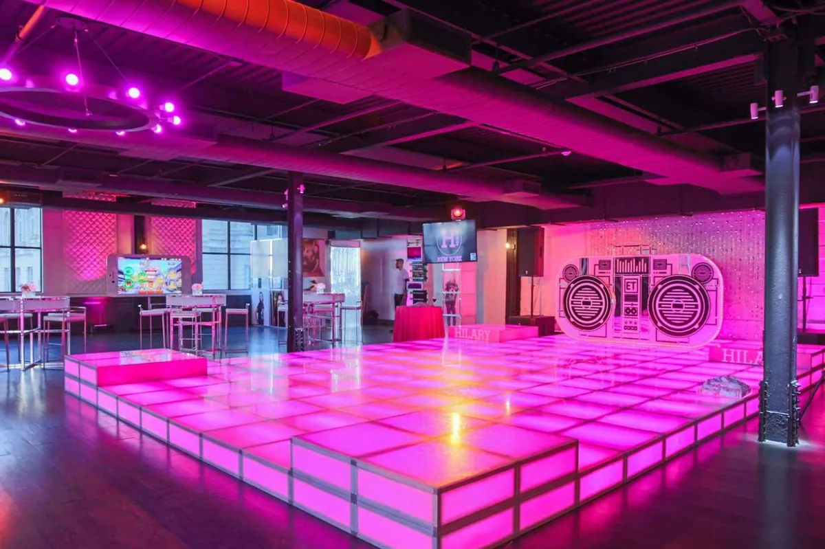Pink LED dance floor and stage built with T3 in a loft party venue