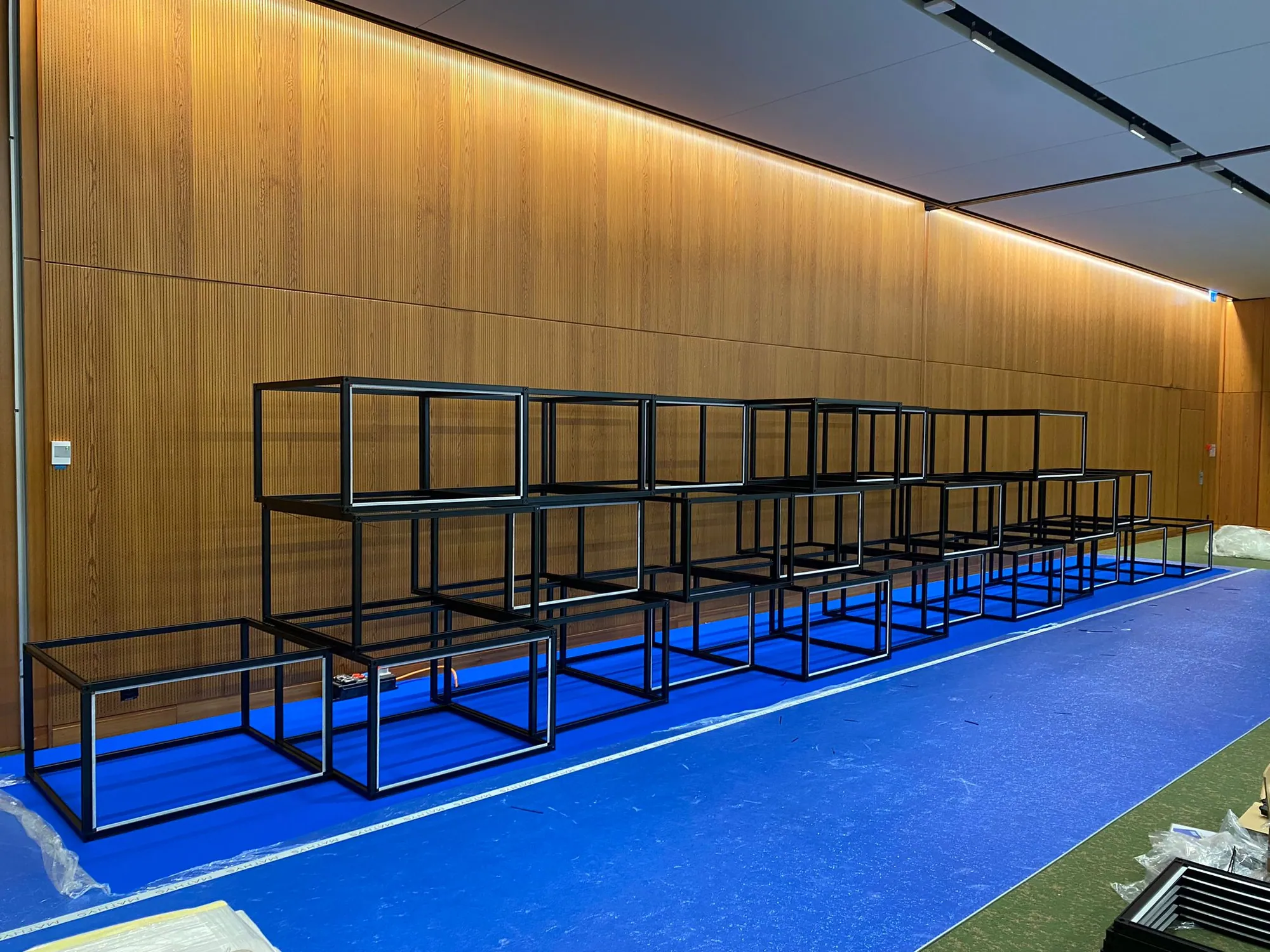 Black T3 Deco cube frames stacked into a wall before graphics are fitted