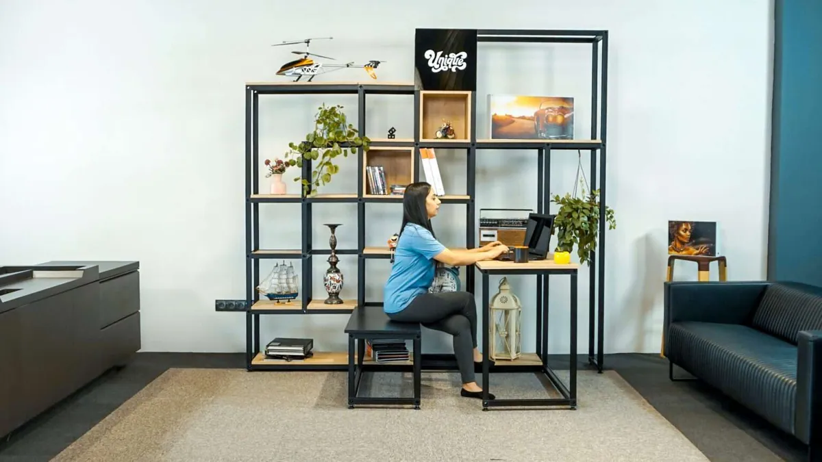 Black T3 Deco frame shelving and desk unit in a modern office workspace
