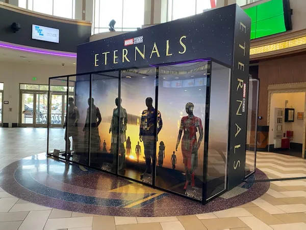 Close view of glazed costume display cases with branded header