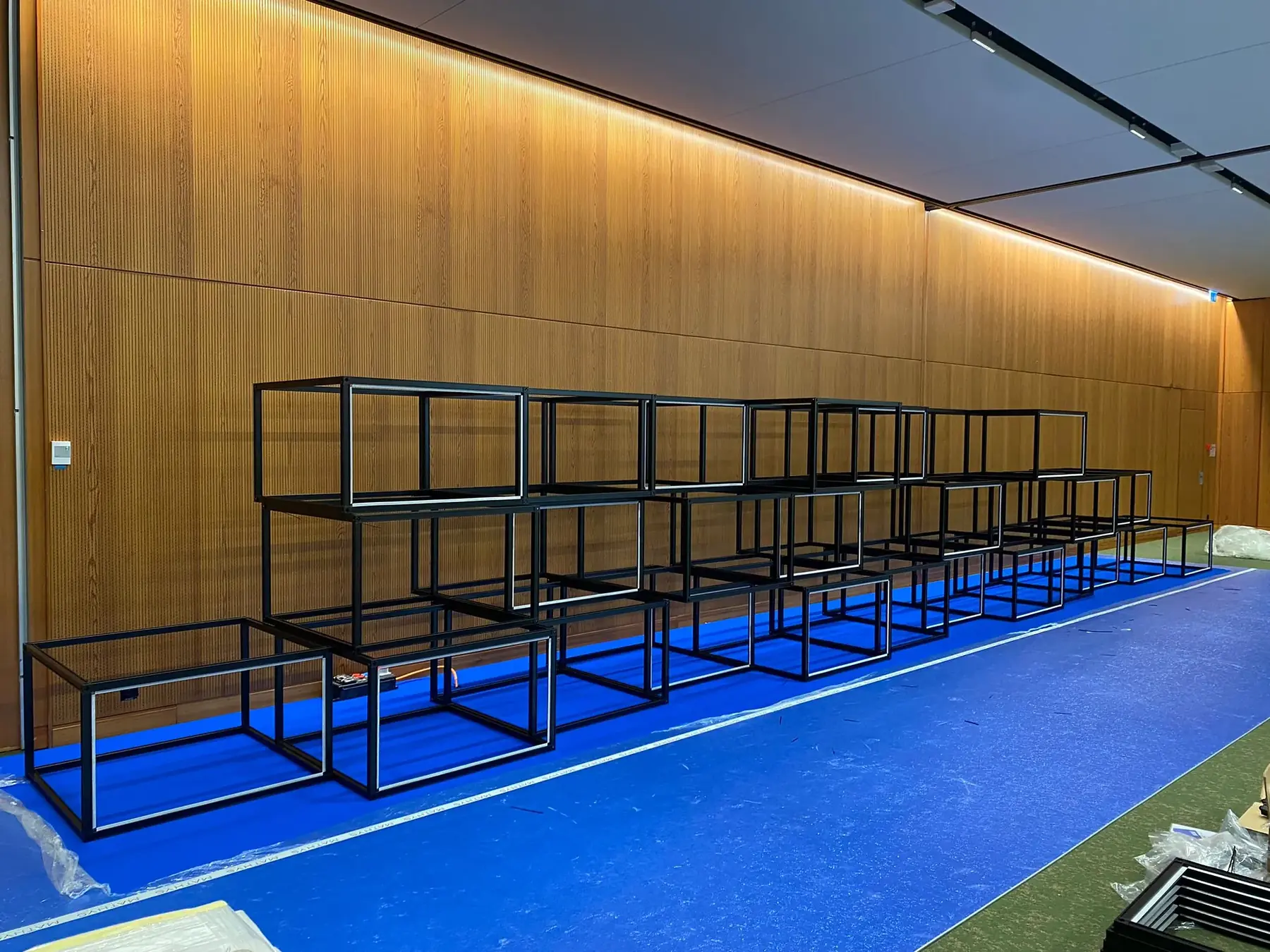 Black T3 Deco cube frames stacked into a wall before graphics are fitted