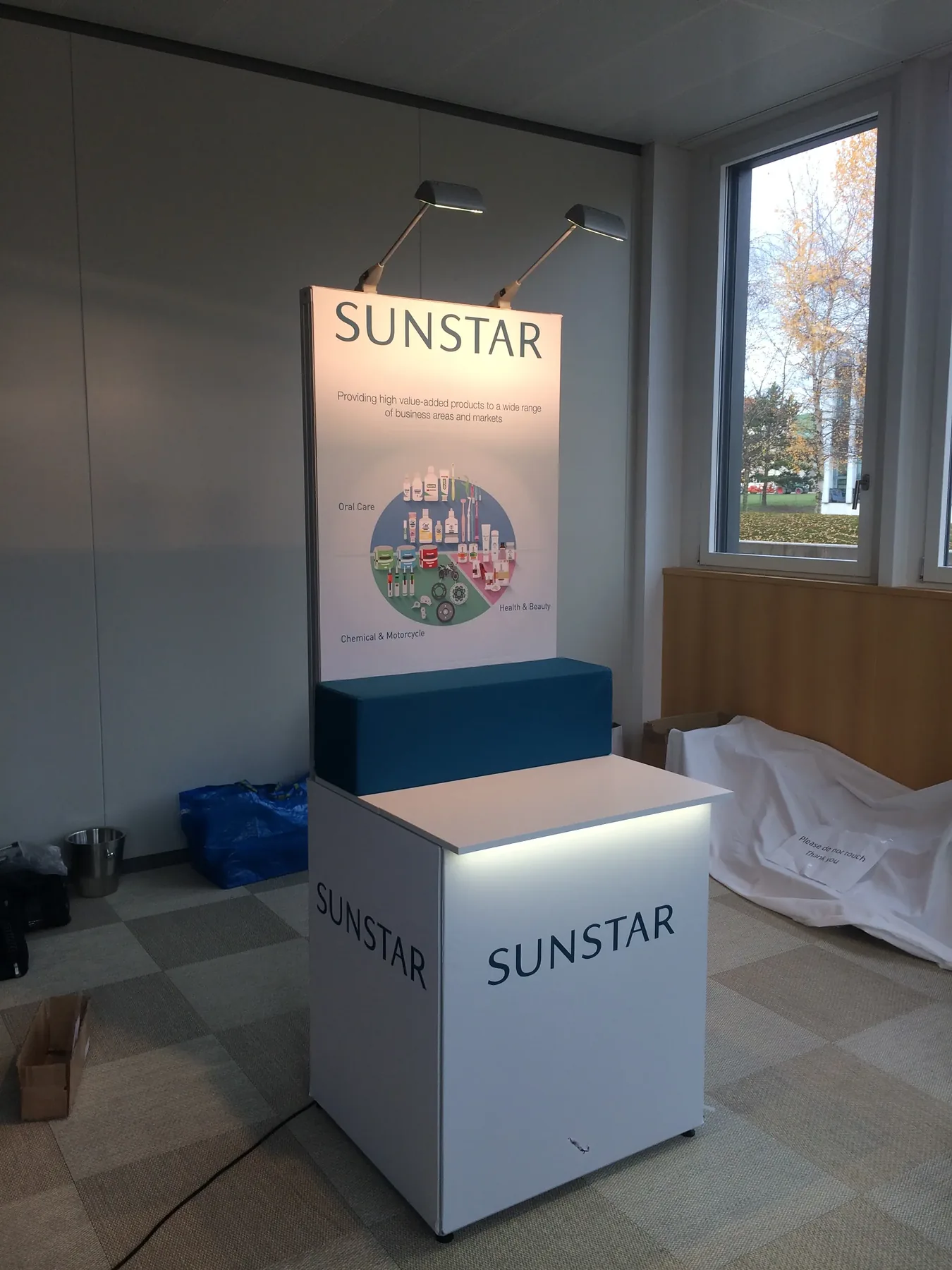 Branded plinth with header panel and spotlights built with T3