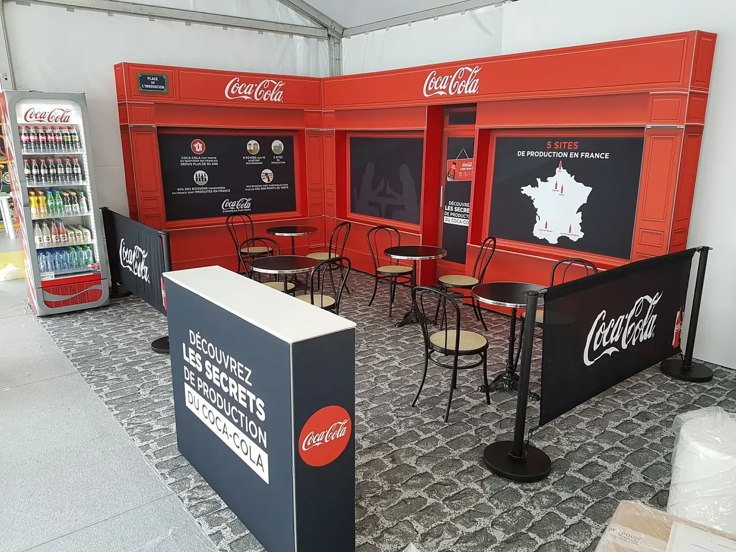 Branded café seating area enclosed by T3 graphic walls
