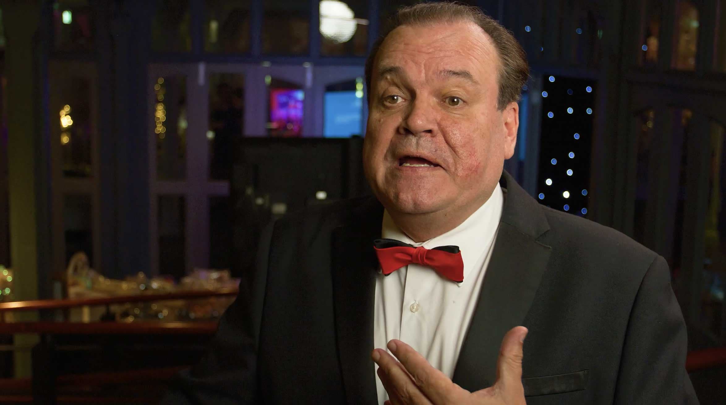 a man in a suit and bow tie