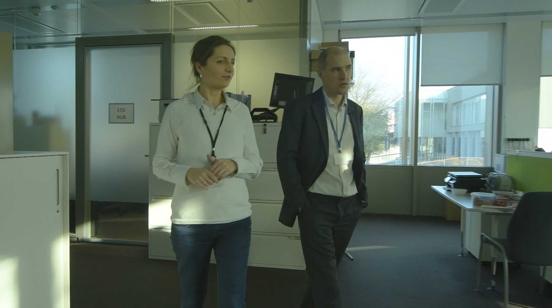 a man and woman standing in an office