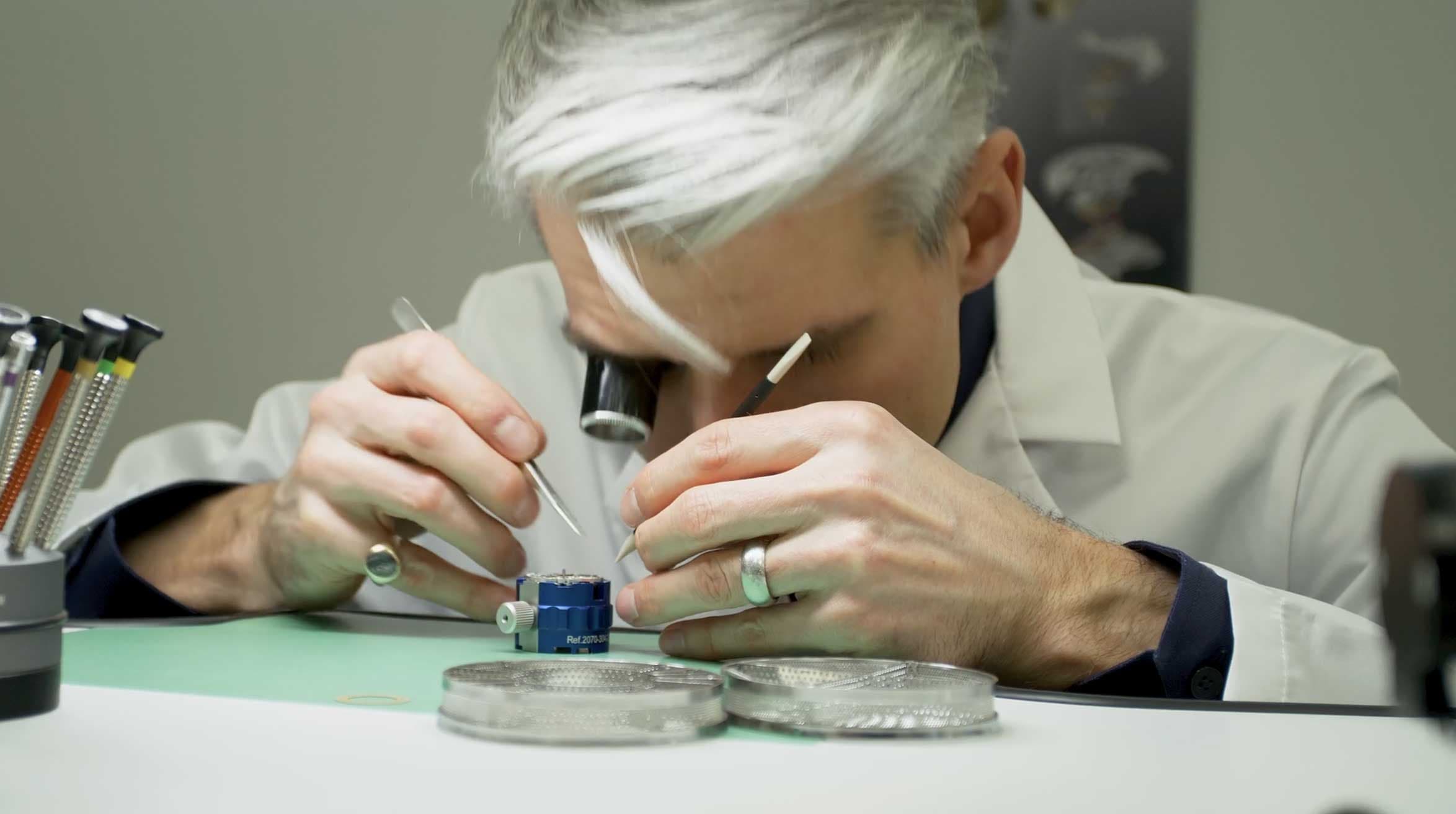 a man looking through a magnifying glass
