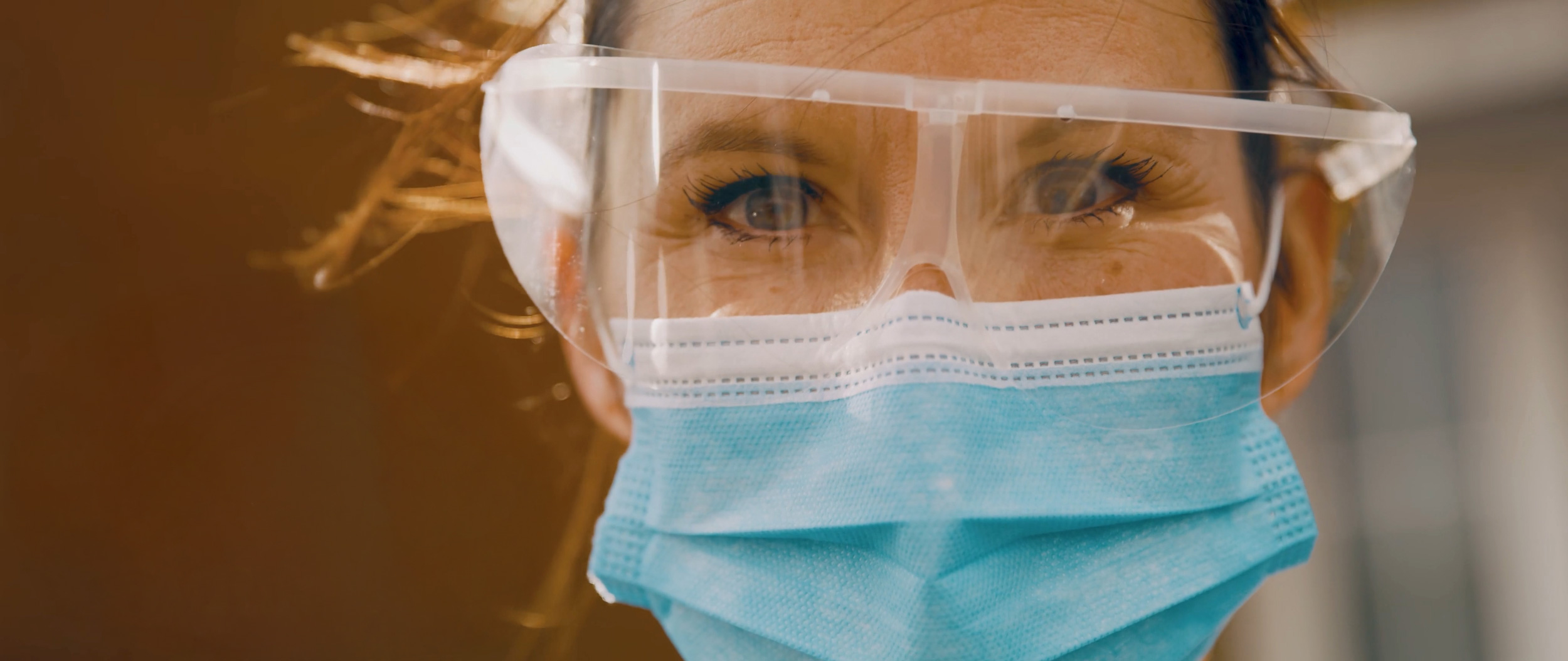 a woman wearing a face mask and goggles