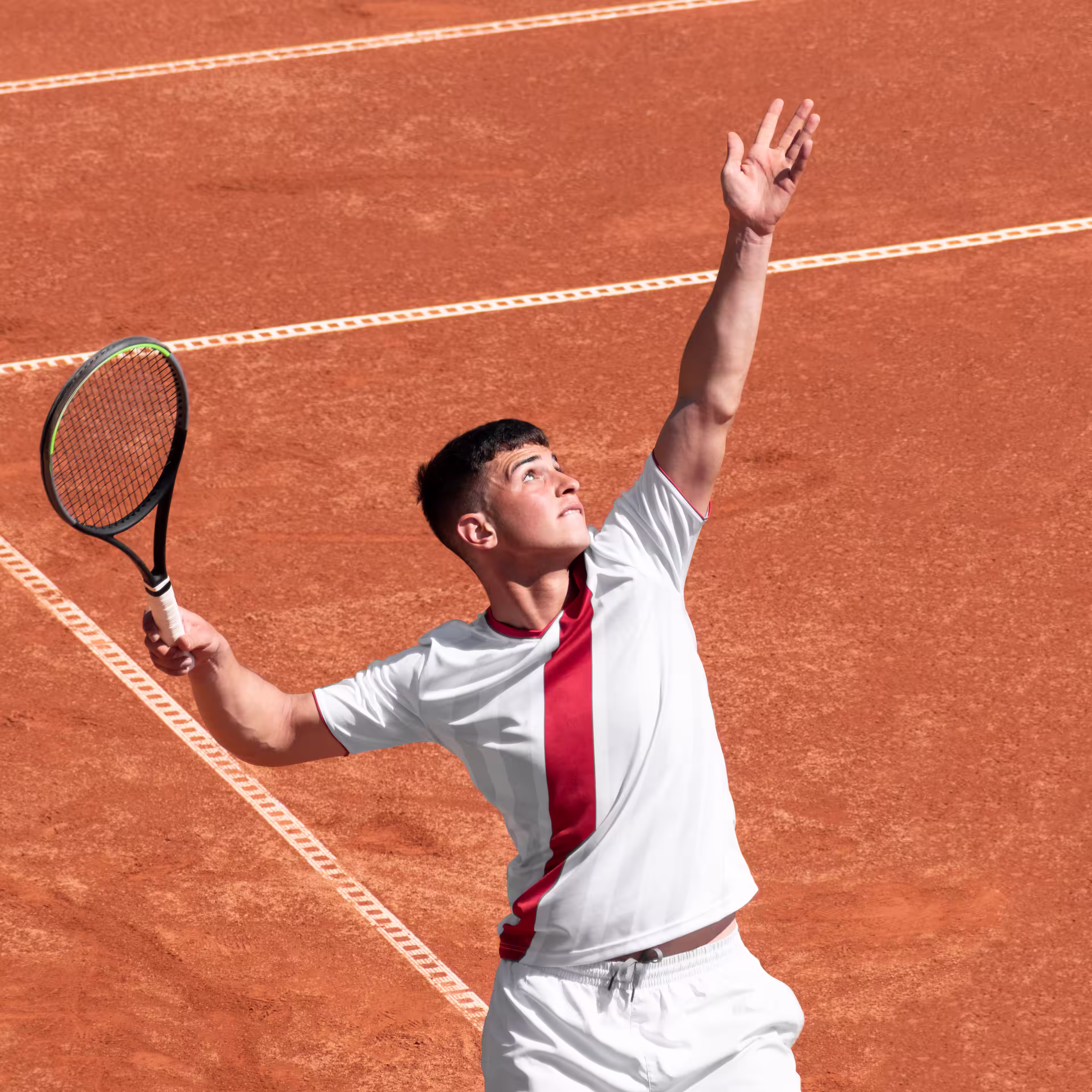 Tennis player in white stares at ball in air while focusing on his serve