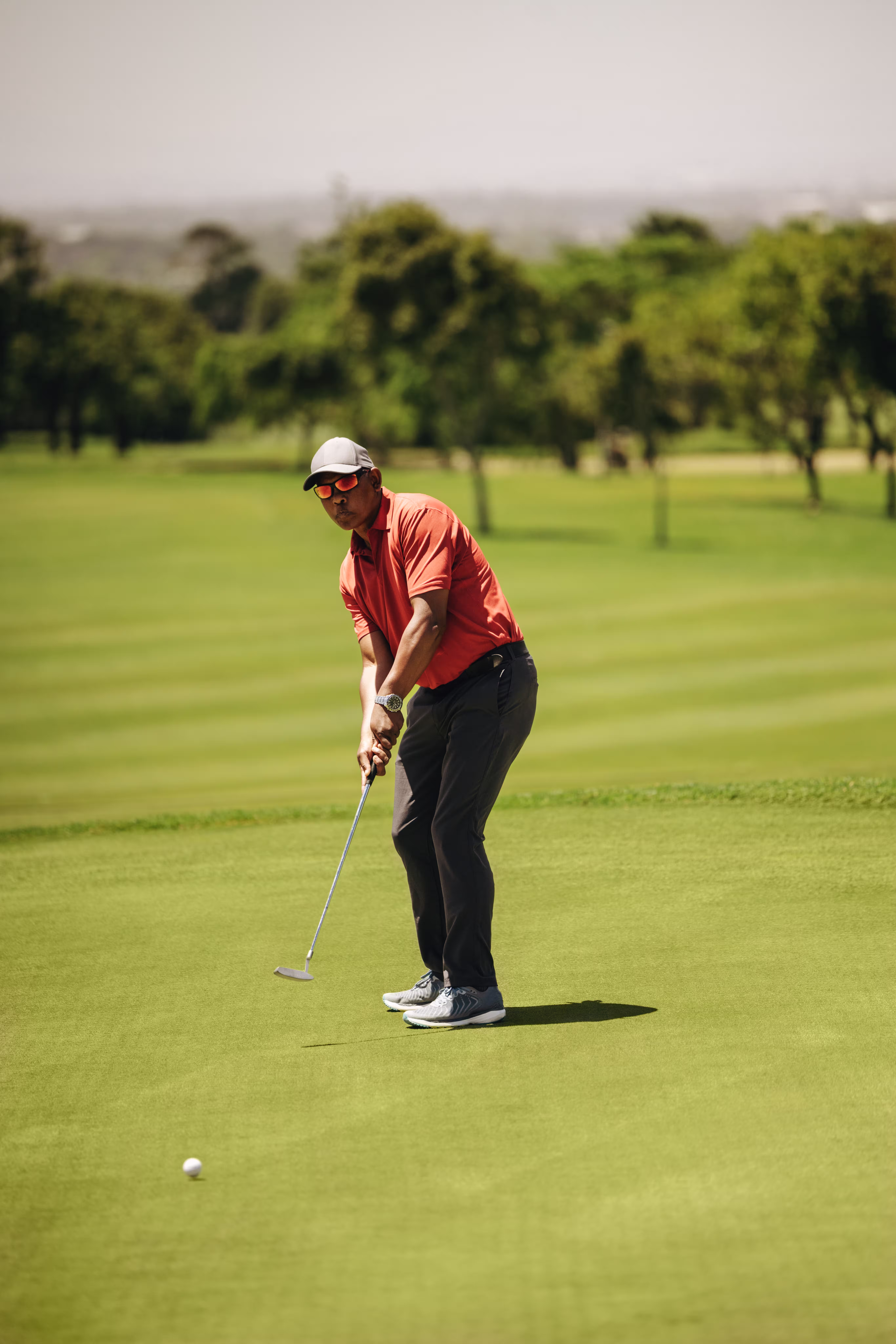 Calm and collected golfer sends a putt toward the hole
