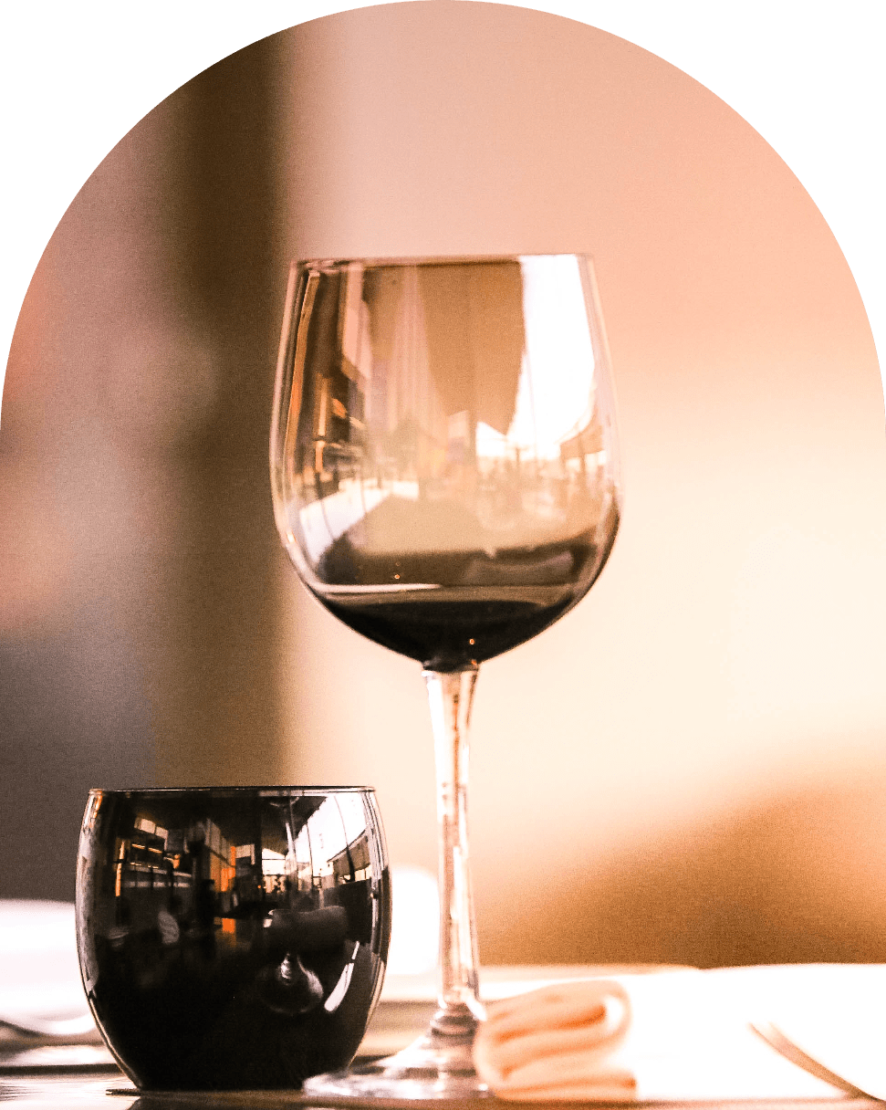 Glass of red wine served in an elegant dining setting at Saint & Second.