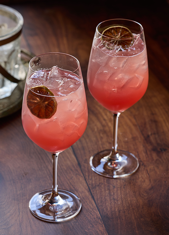 Handcrafted citrus cocktail garnished with a fresh lime wheel, served at Saint & Second.