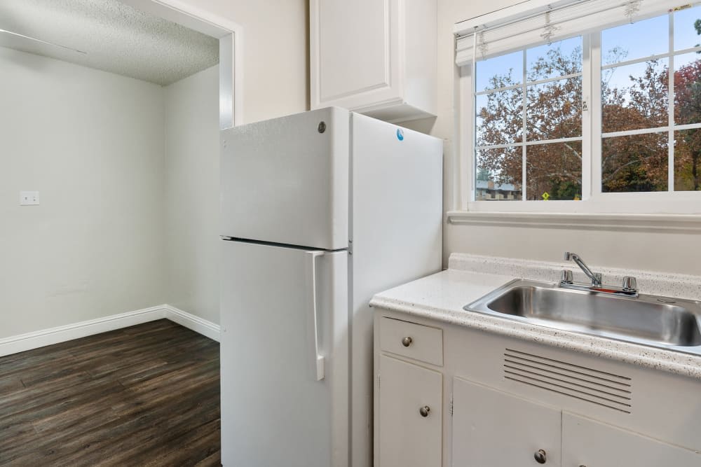 Kitchen with white cabinets and white appliances