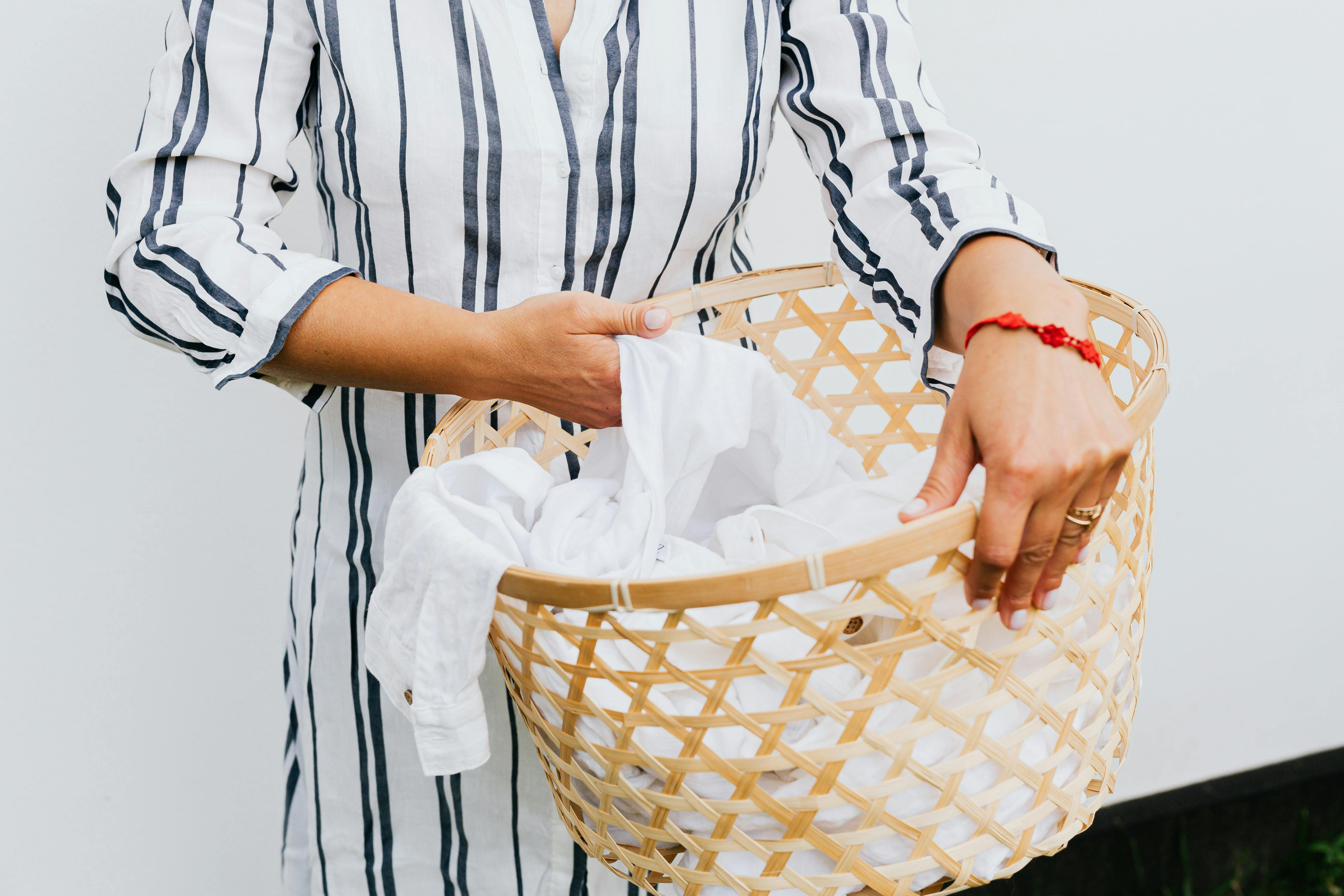 Woman holding laundry basket stock image