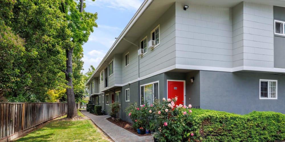 Exterior of homes with walking pathway and rose bushes