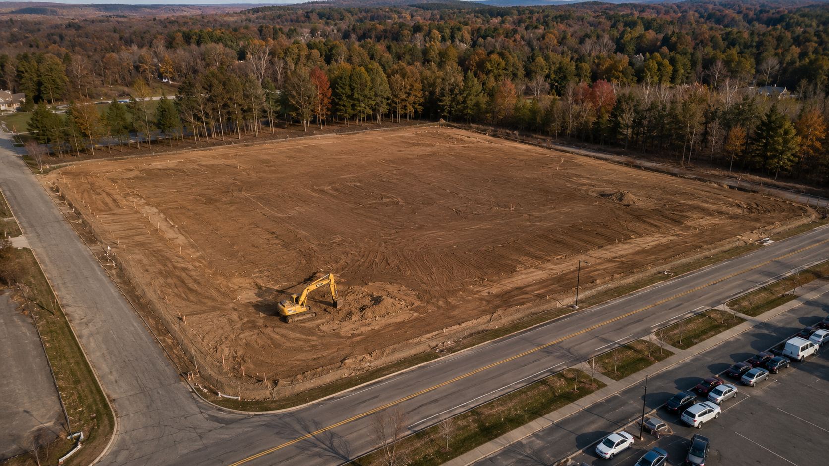 Aerial progress documentation — flight 1 of 4, site cleared and graded