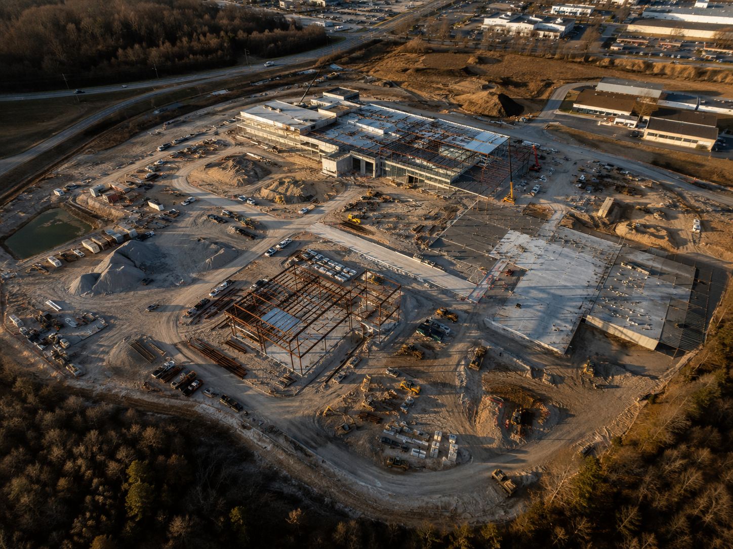 Wide aerial view of an active construction site documented by drone