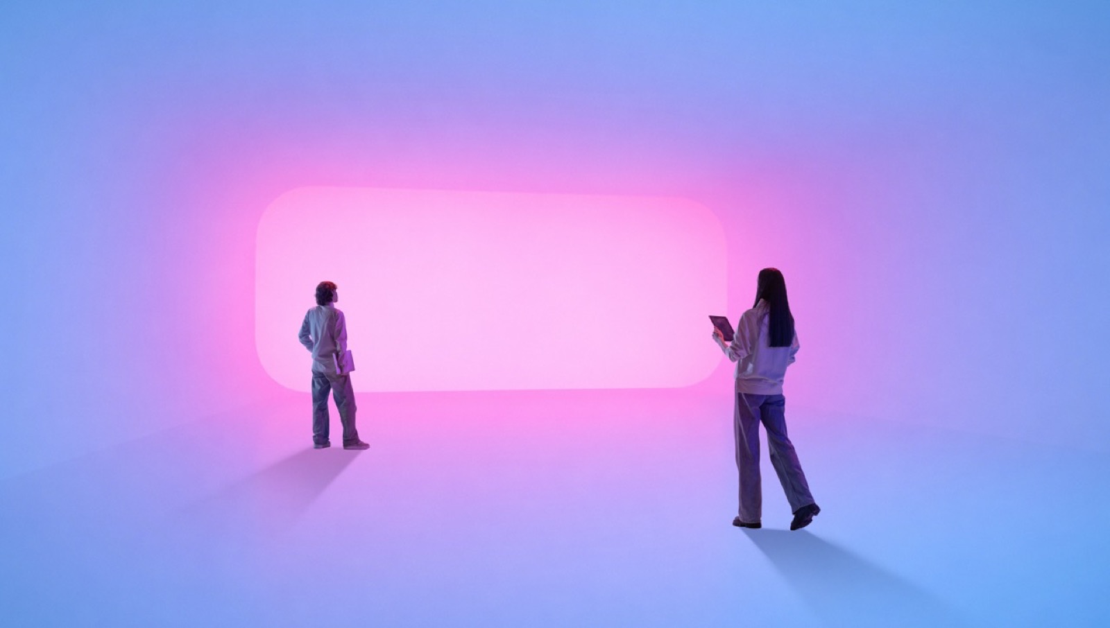 Two figures stand in a room washed in violet light, facing a glowing color field.