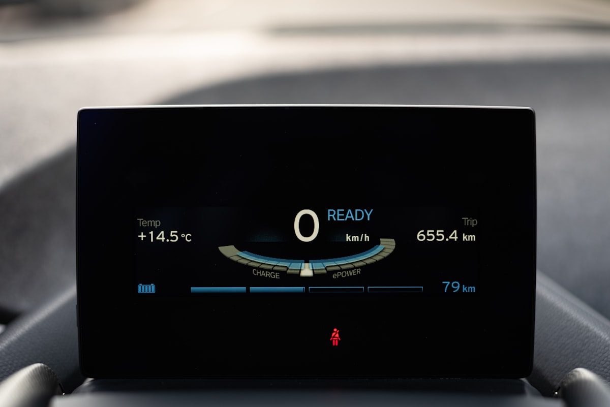 Electric vehicle display showing battery charge level, range, and power status