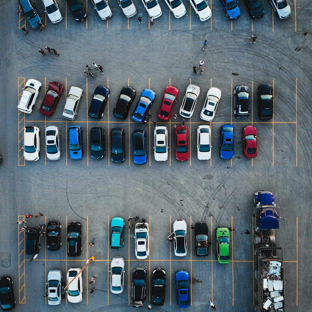 Aerial view of a large car lot with rows of parked vehicles