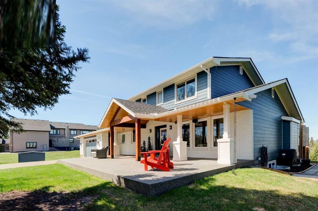 Bearspaw home rear elevation after EnerClear transformation with new covered main-level deck and Evening Blue Hardie siding