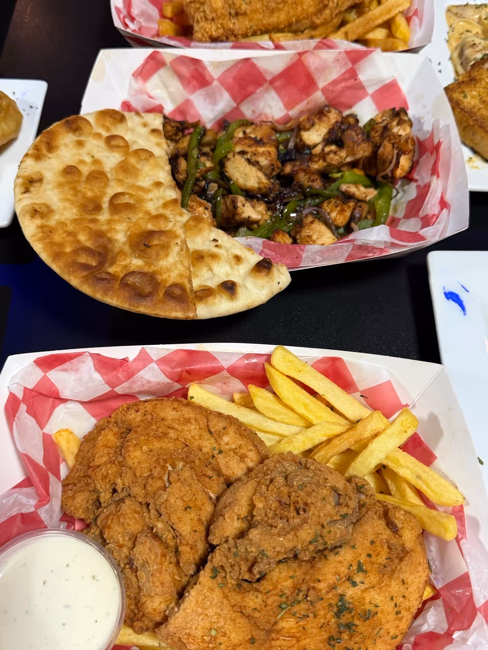 fried chicken with fries and a plate of chicken fajitas