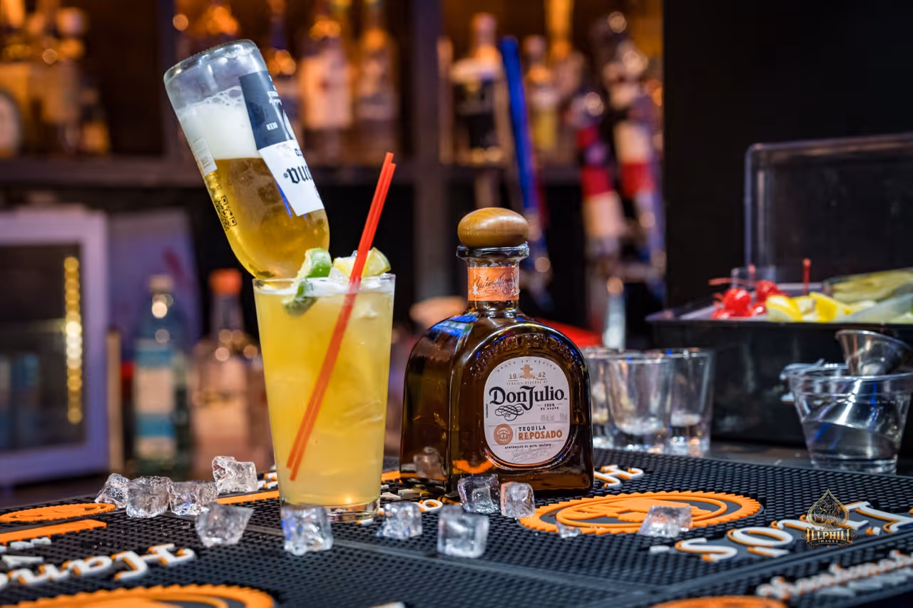 a glass of paloma with a beer on top