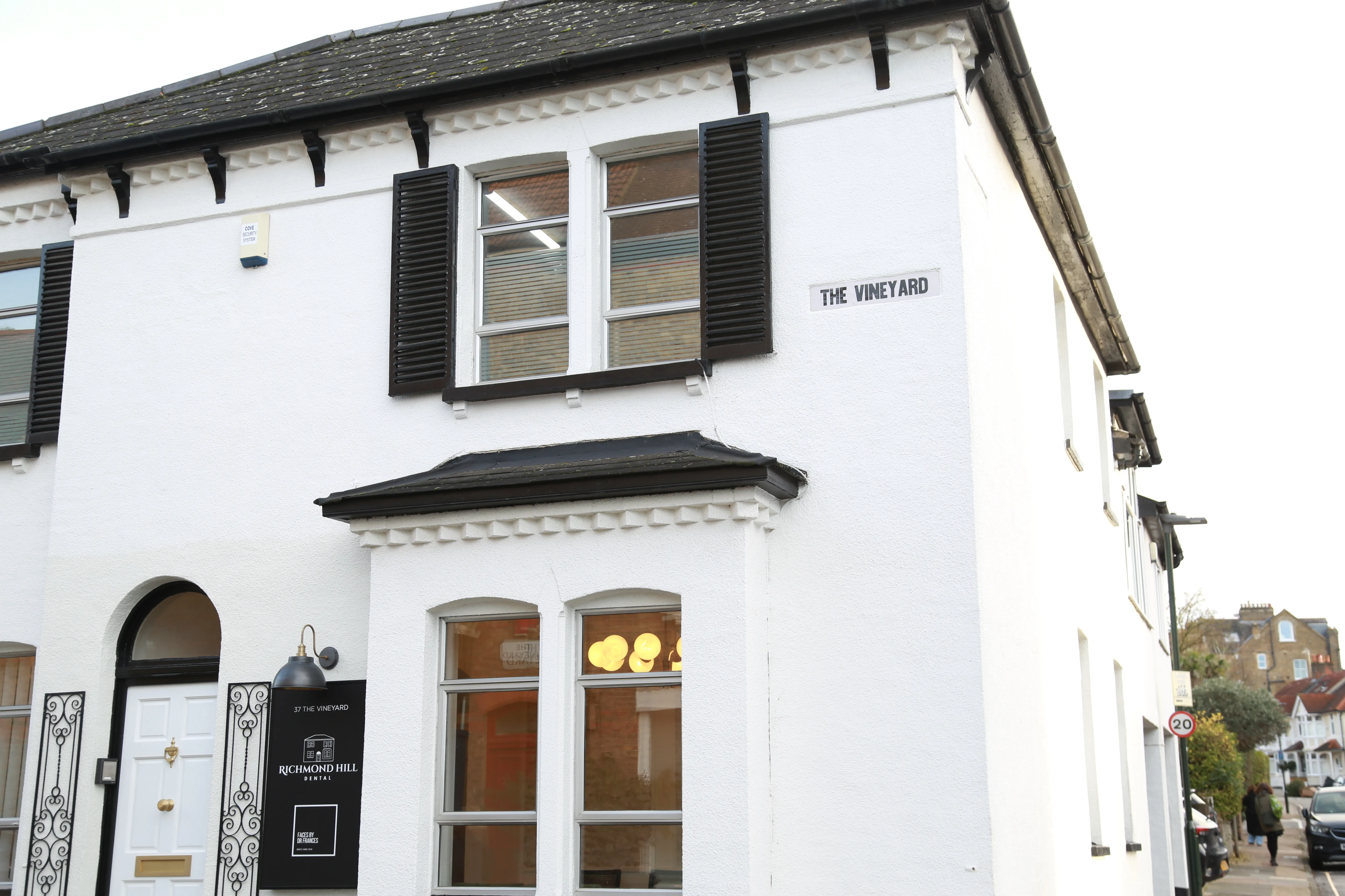 White building with black shutters labeled The Vineyard housing Richmond Hill Dental office.