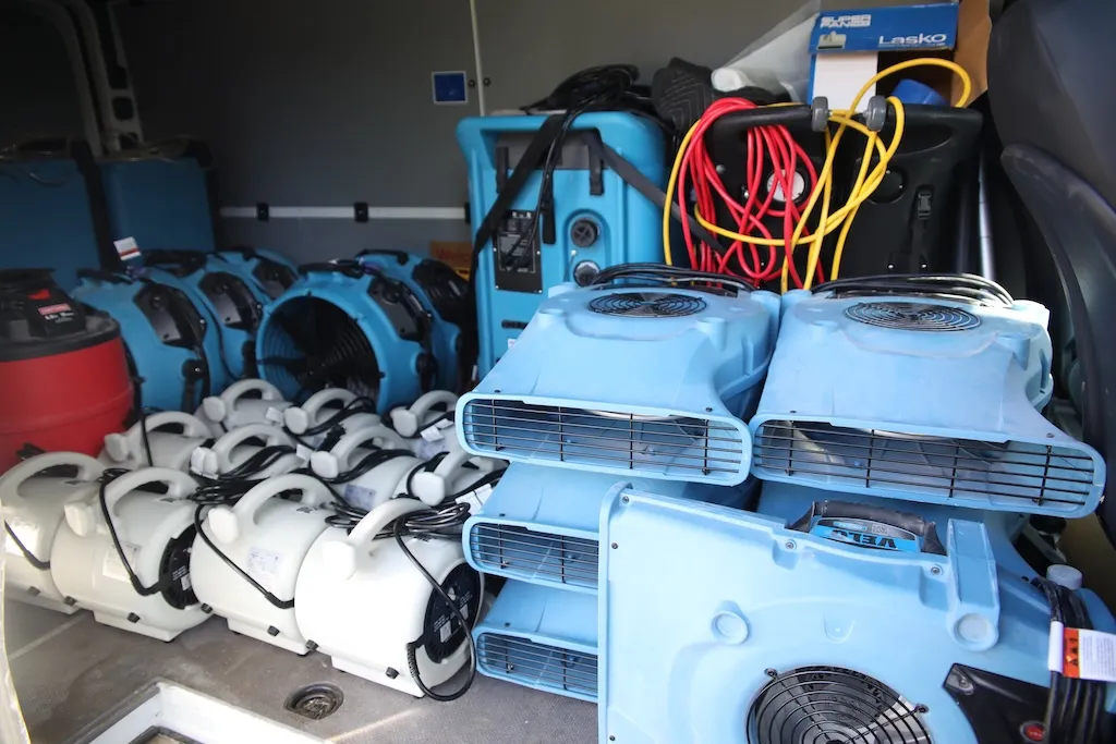 Service van loaded with air movers, dehumidifiers and extraction equipment