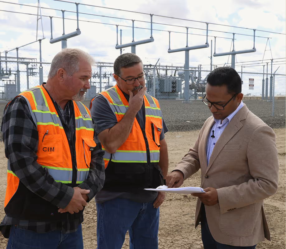 Employees in front of substation on site at Permanent Power Company in San Joaquin Valley, California