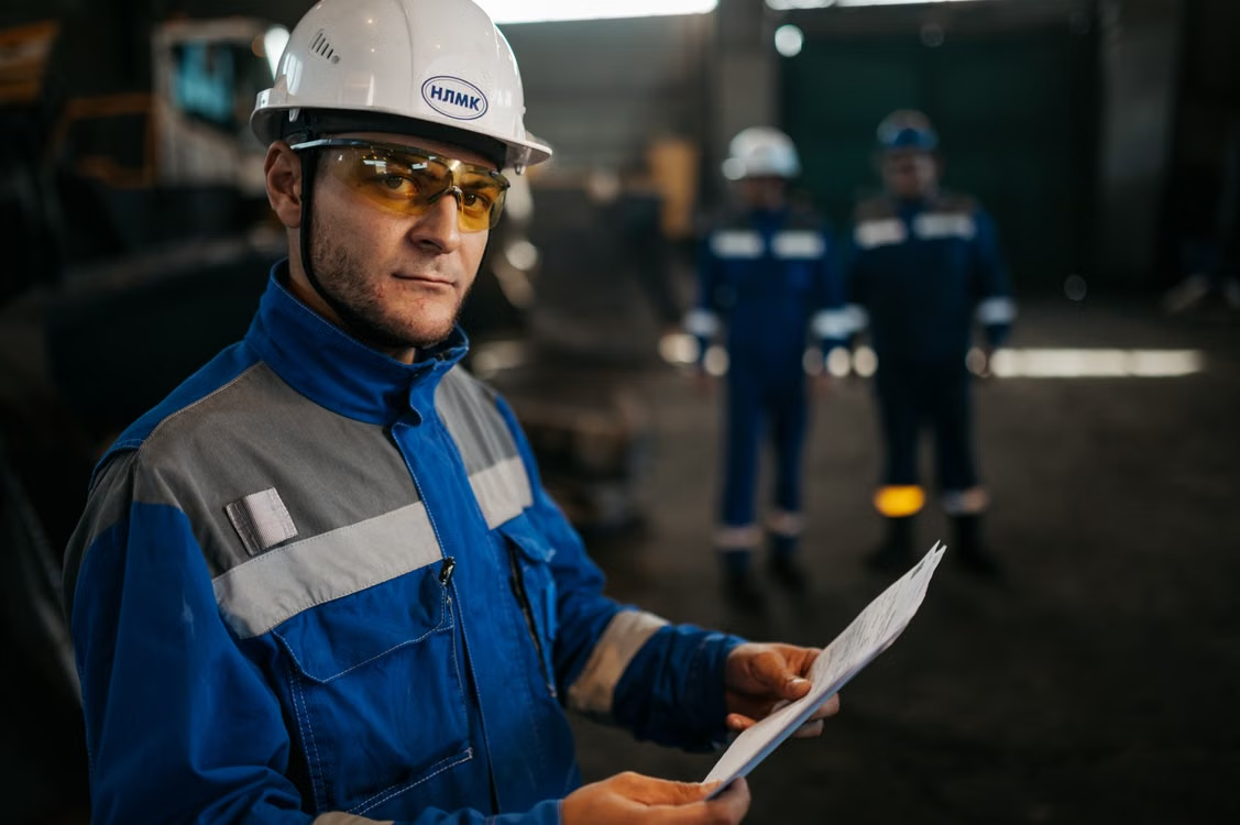 refinery worker reviewing safety documentation