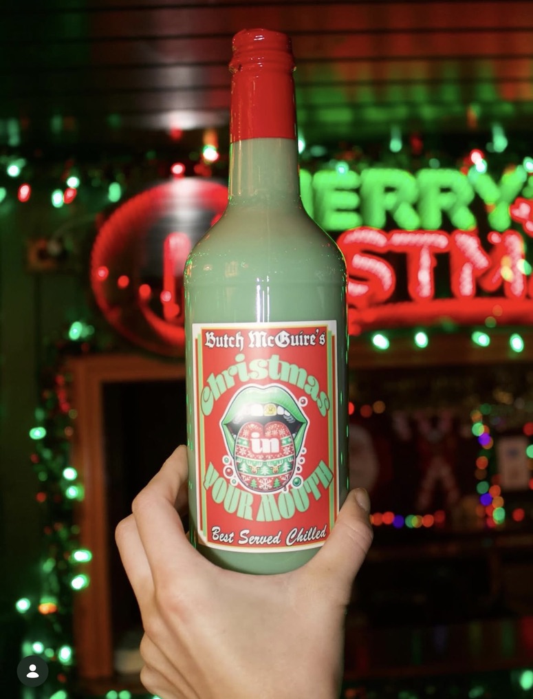 Snowflakes and ornaments over the bar, with a sign reading Wanna go to Butch McGuire's
