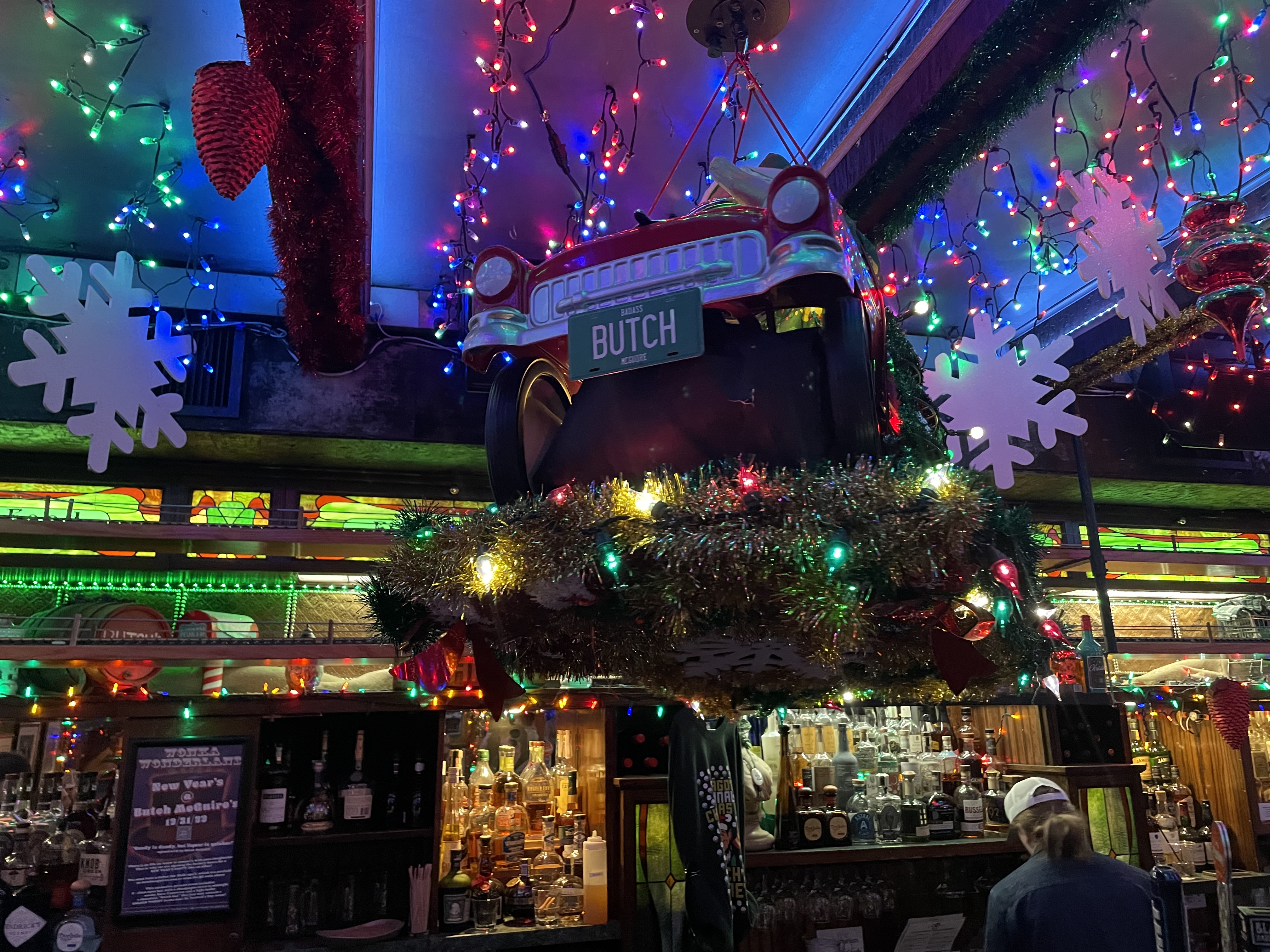A classic car ornament with a BUTCH license plate hanging above the bar
