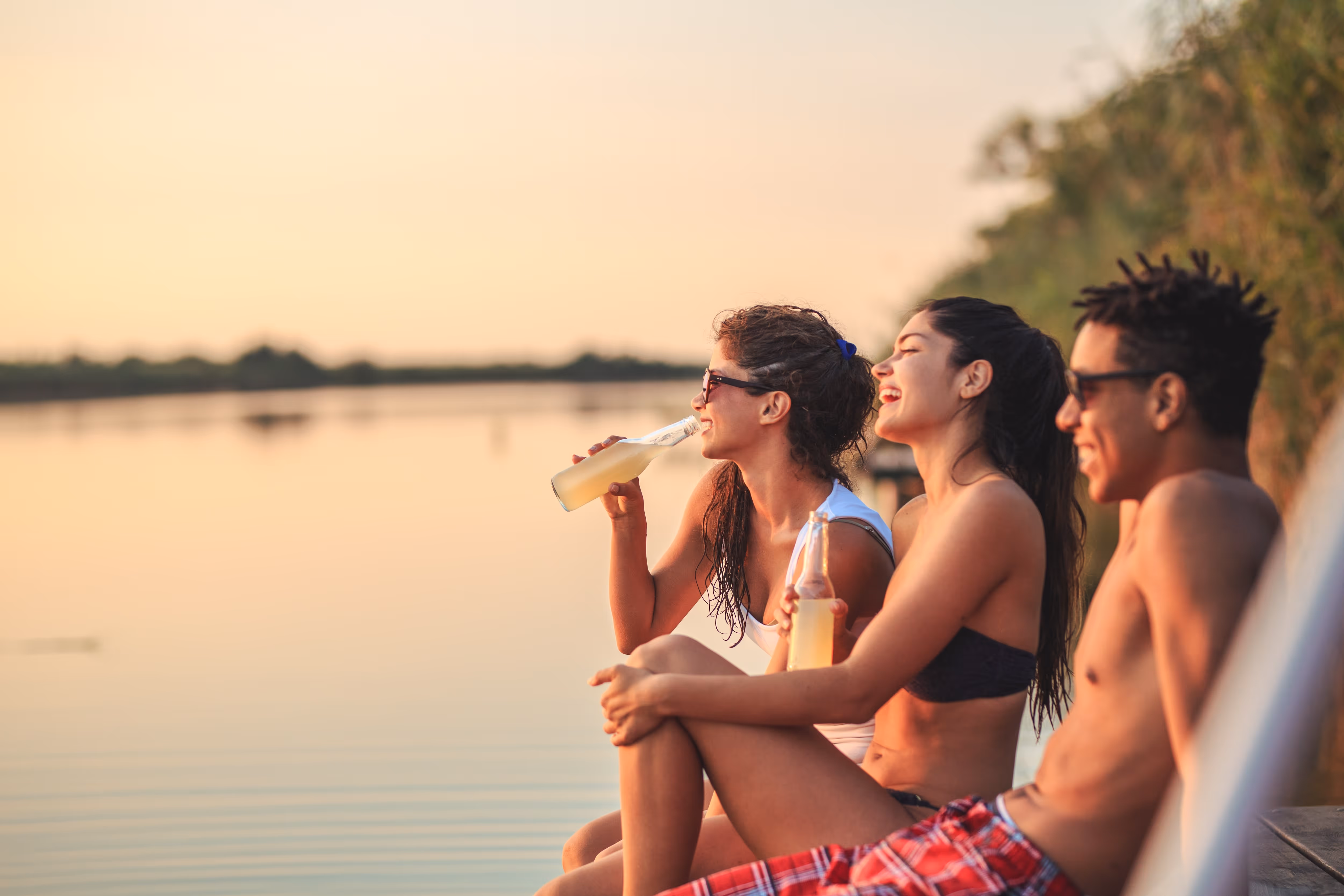People sitting by water stock image