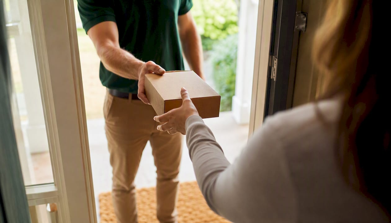 Hand receiving medication delivery package