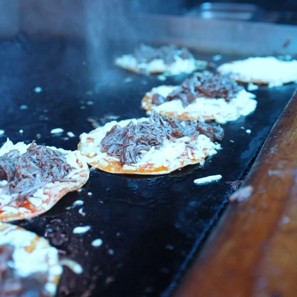 Birria Tacos being Grilled inside Taco Joe's Food Truck
