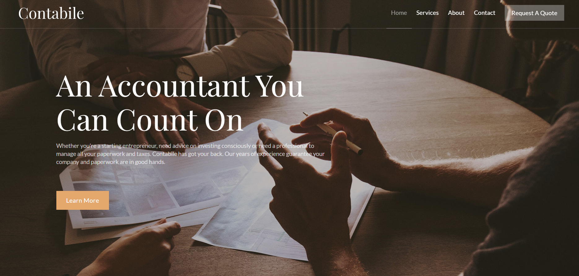 Two people discussing paperwork and charts at a round wooden table with text about accounting services.