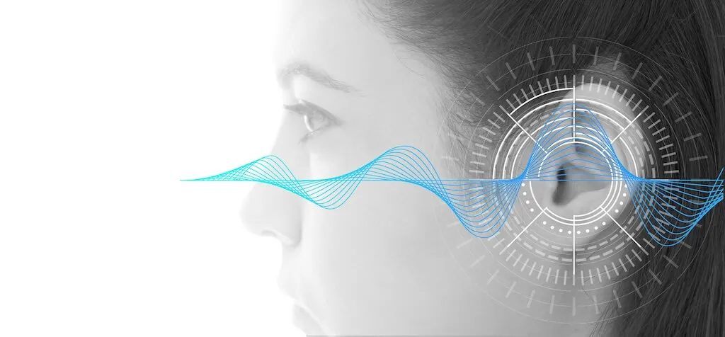 Side profile of a woman with blue sound waves and circular graphics over her ear symbolizing hearing or sound technology.