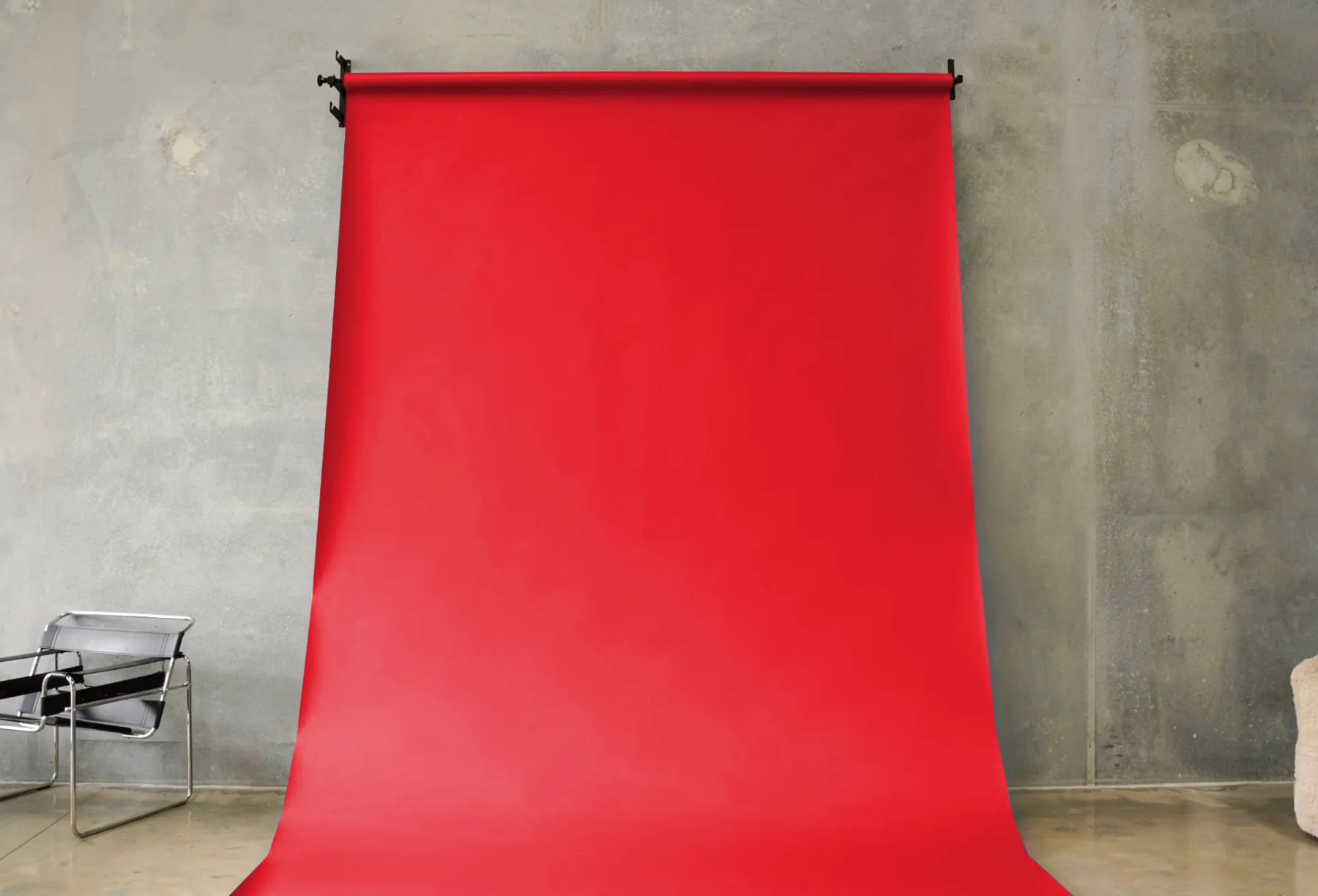 Red seamless paper backdrop hanging in the BLANK studio