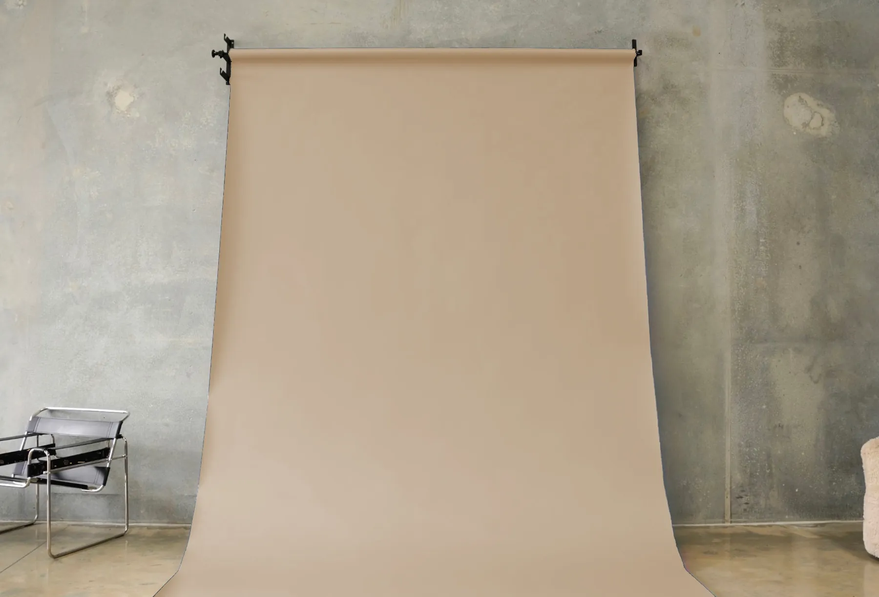 Beige seamless paper backdrop hanging in the BLANK studio