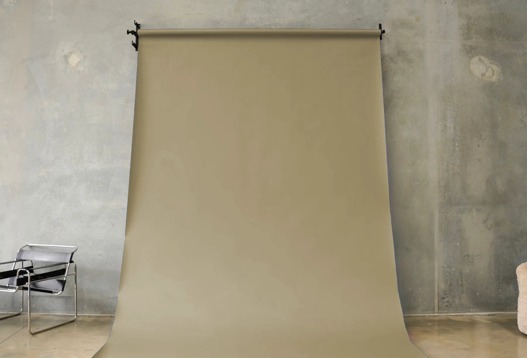 Khaki seamless paper backdrop hanging in the BLANK studio