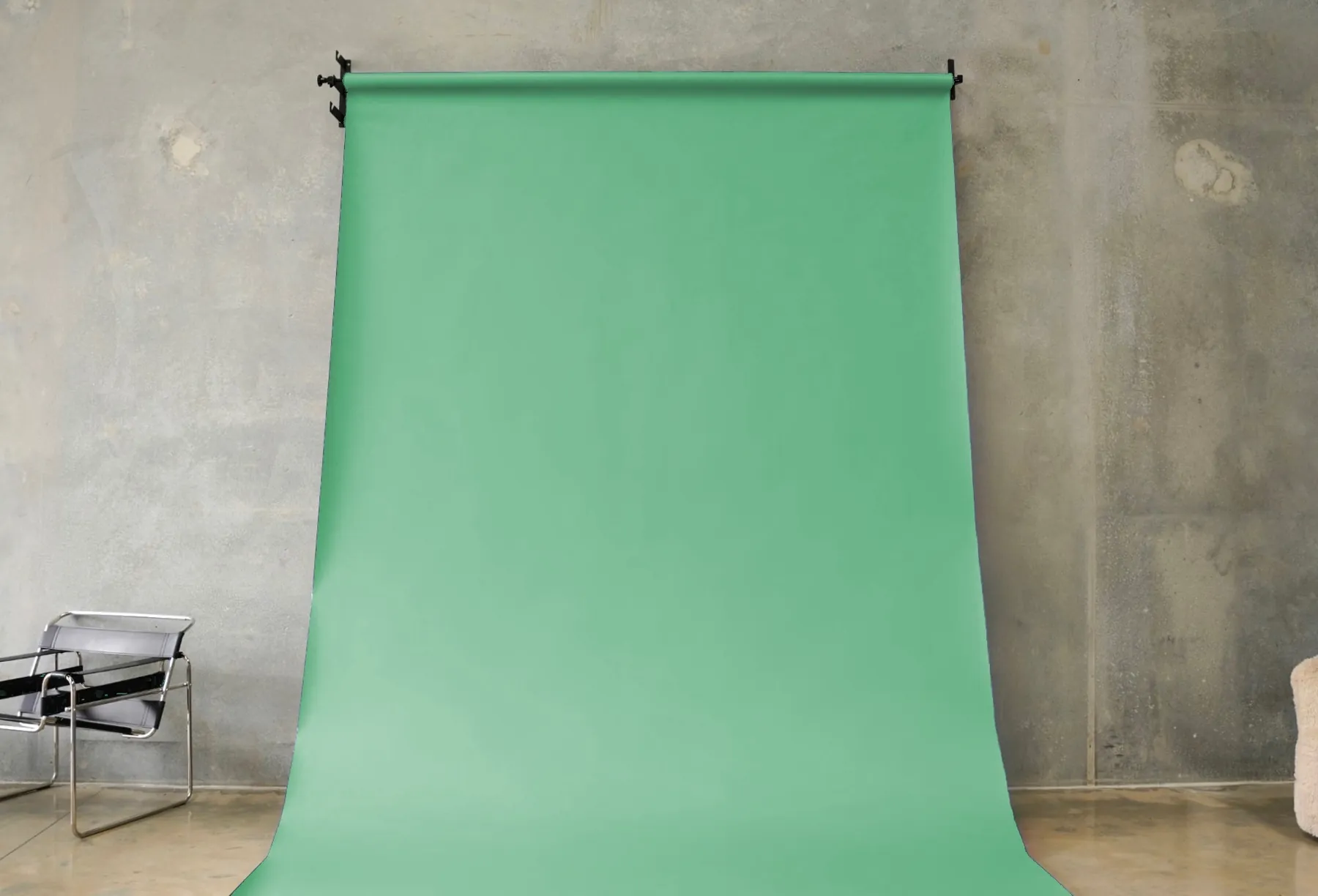 Green seamless paper backdrop hanging in the BLANK studio