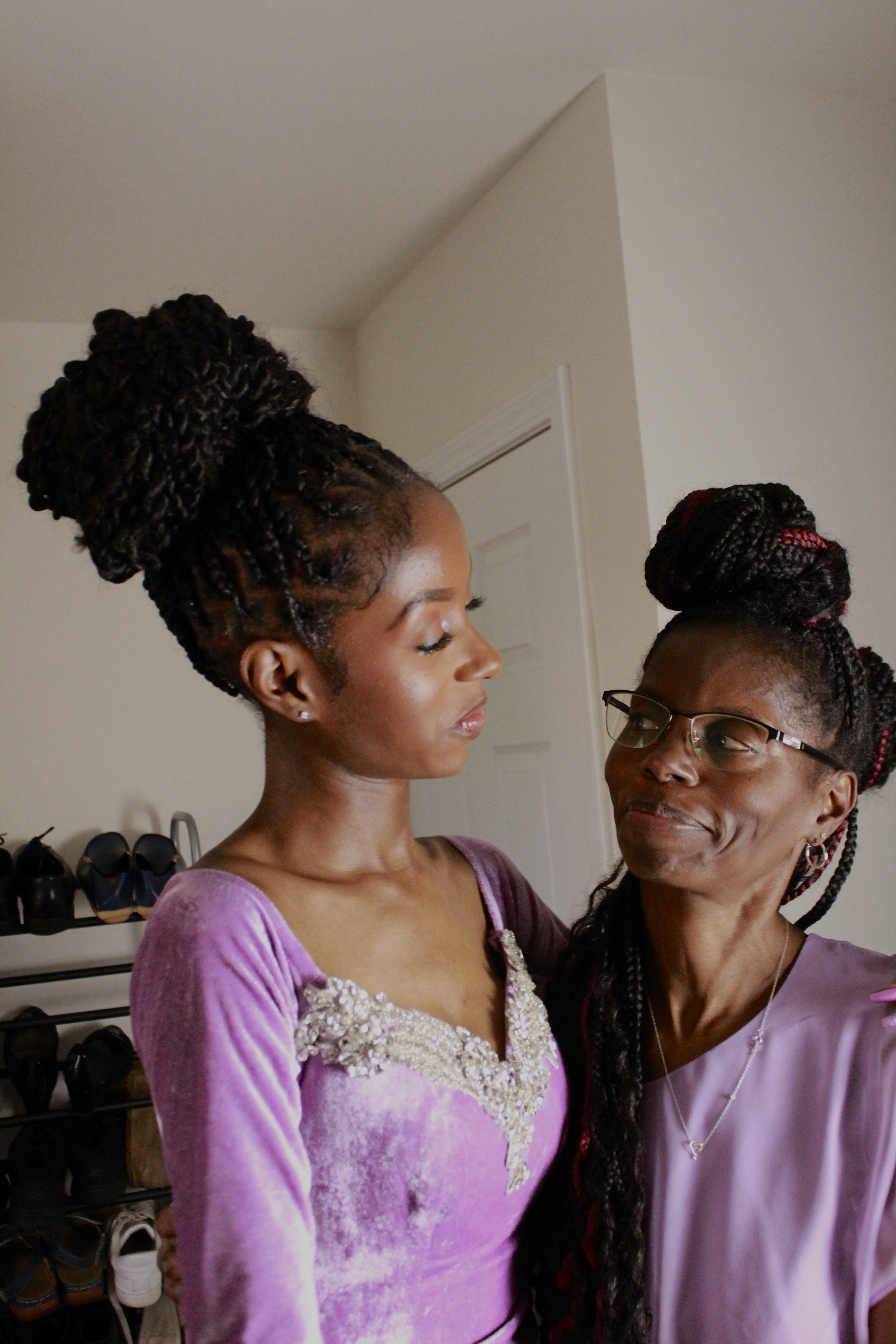 A senior on her prom day embraces her crying, yet proud mother.