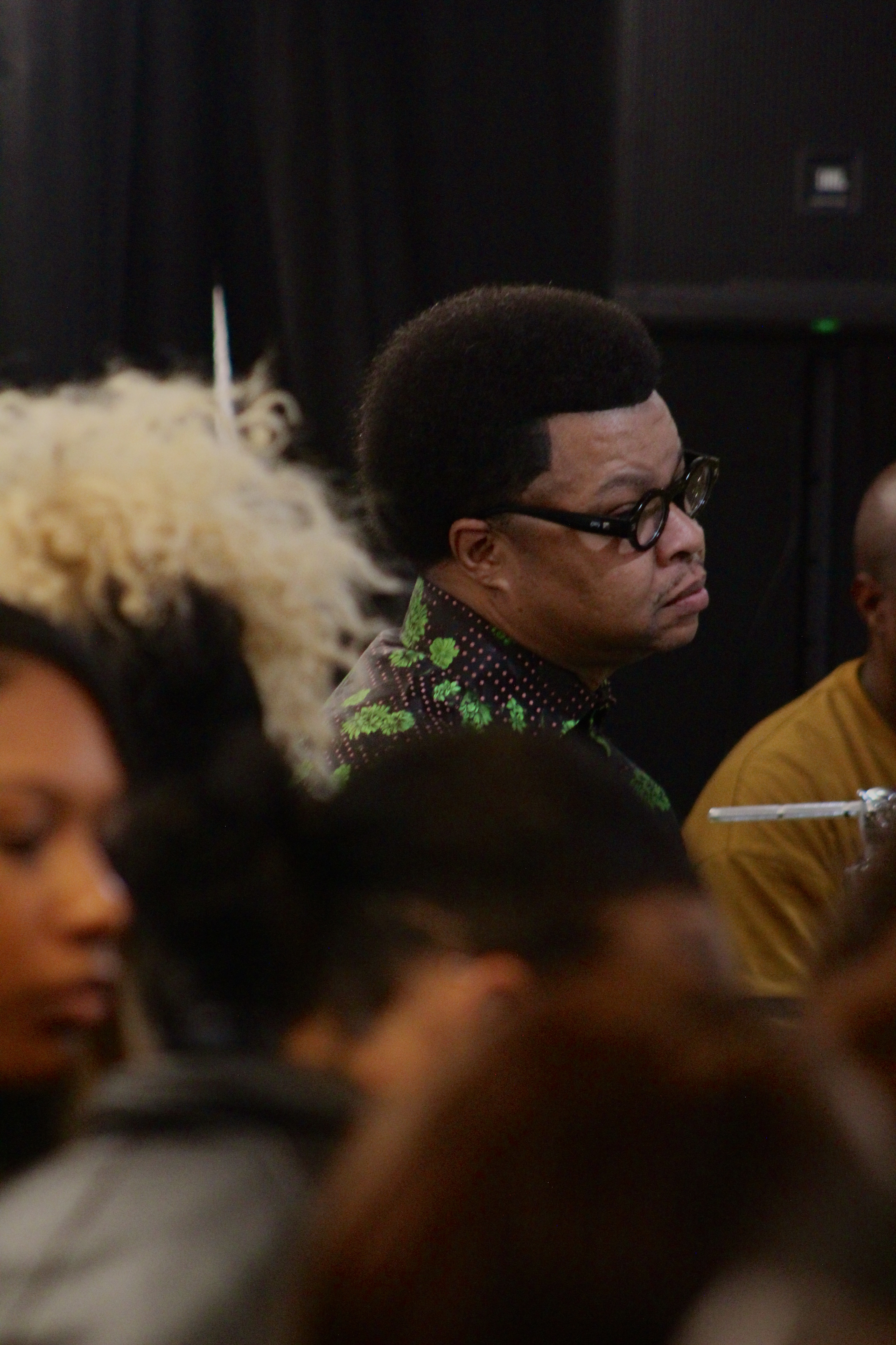 Beyond the blurred congregation, Michael Mindingall sits in awe.