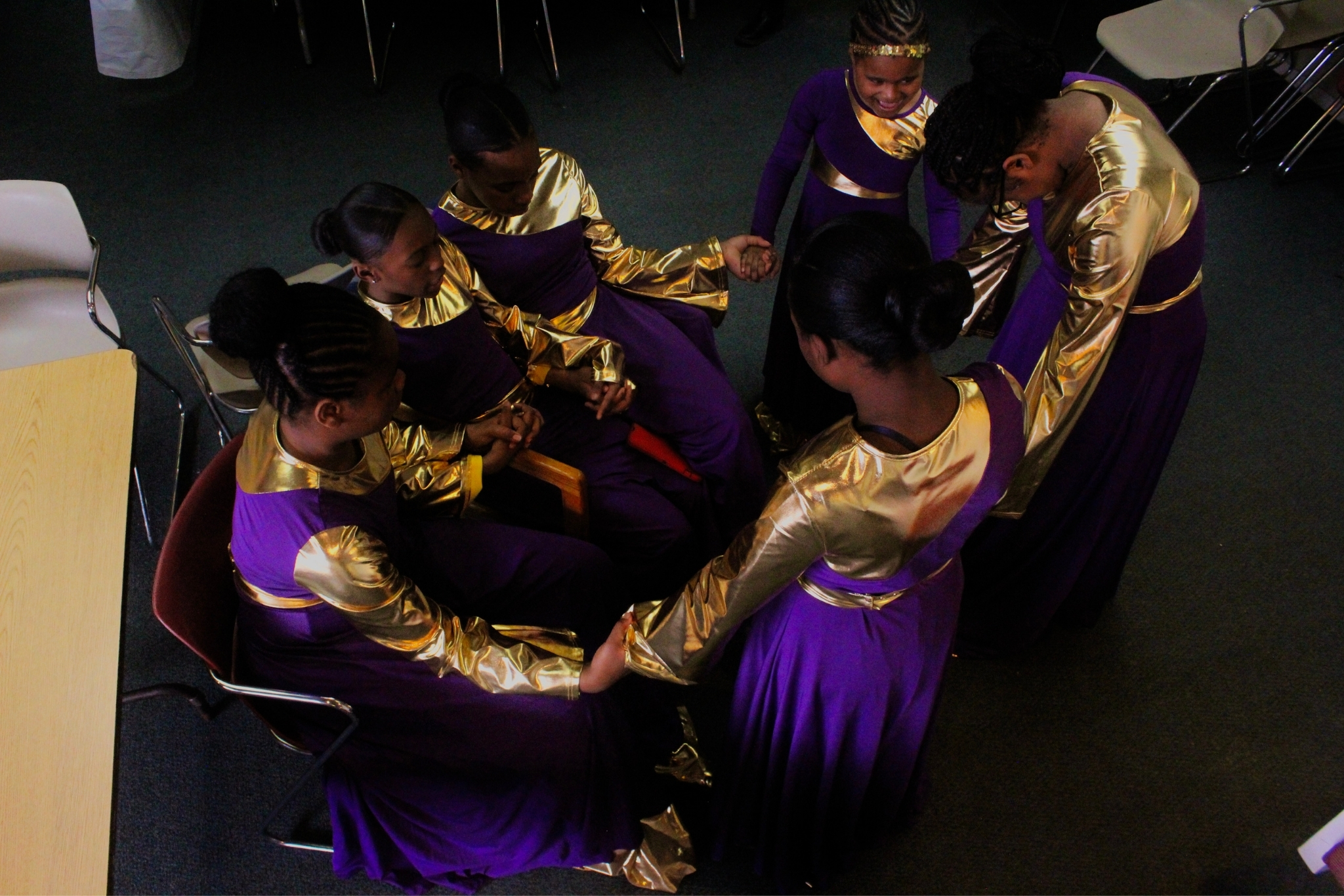 In this overhead image, I.G.W.T. Dance ministers gather together, lowering their heads in prayer.