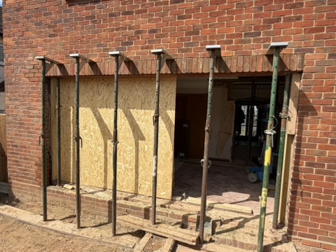 Structural opening propped with acrow props during load-bearing wall removal