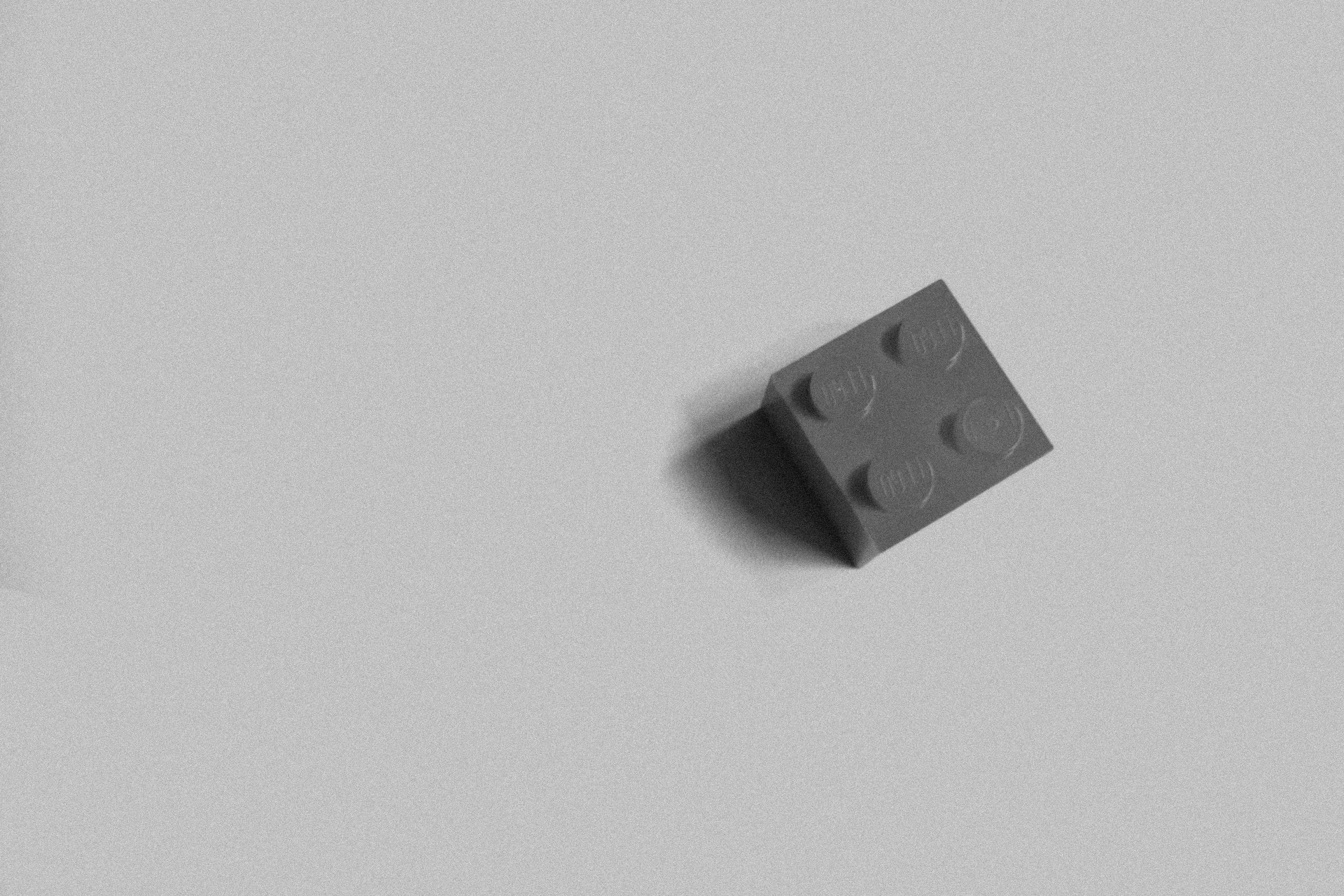 An building block toy on a white surface, symbolising the foundational building blocks and modular constraints of the tiny house design challenge.