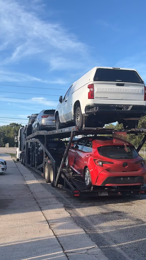 Multiple cars loaded onto a car hauler truck in Florida shipped by EcoHub Logistics
