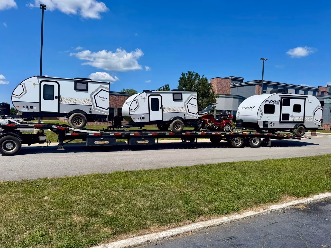 Three trailers atttached to car haules - process of shipping trailers by EcoHub Logistics
